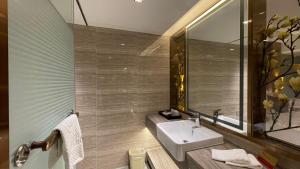 a bathroom with a sink and a mirror at Oriental Silk Hotel in Guangzhou