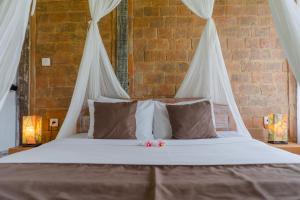 Postel nebo postele na pokoji v ubytování Ananda JJ Ubud Resort & Spa
