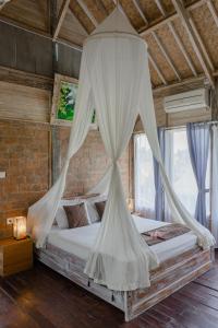 Postel nebo postele na pokoji v ubytování Ananda JJ Ubud Resort & Spa