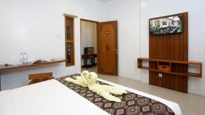 Postel nebo postele na pokoji v ubytování S5 Guest House Yogyakarta