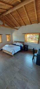 a bedroom with a bed and a chair in it at Casa Primitivo in Barichara