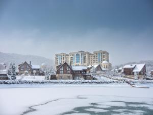 a resort in the snow with a frozen lake at Quba Palace Hotel & Golf Resort in Quba