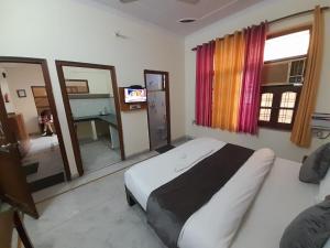 a bedroom with a bed and a television in it at Hotel The Holiday Home in Rishīkesh