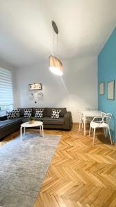 a living room with a couch and a table at Apartment Saraj-Bosna Free public Parking in Sarajevo