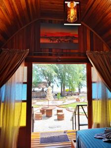 a view from the inside of a room with a window at Mumsa Beach Resort & Restaurant in Ban Huai Yang