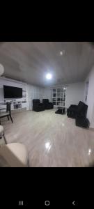 a large living room with couches and a flat screen tv at Penthouses La Fe in Cartagena de Indias