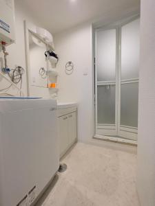 a white kitchen with a large window and a counter at 3-1 New Open地下鉄徒歩4分　美室【サービスアパートメントSapporo大通東3】3-1 in Sapporo +35 photos