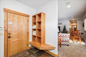 a room with a wooden cabinet and a living room at Lone Hand Lodge in Breckenridge