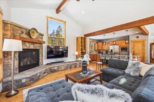 a living room with a couch and a fireplace at Lone Hand Lodge in Breckenridge