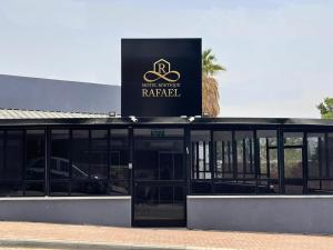 a building with a sign that reads park rental at בוטיק רפאל Boutique Rafael in Eilat