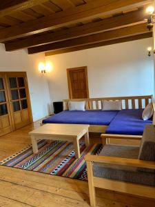 a room with two beds and a table in it at VIP MiKU apartman 2 in Mikulov
