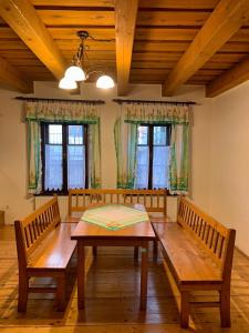 a dining room with a wooden table and two benches at VIP MiKU apartman 2 in Mikulov