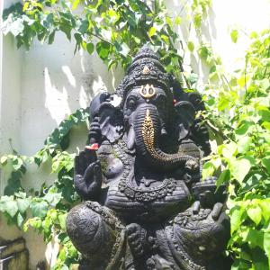 a statue of an elephant standing in a garden at The Joglo Kedungu, Traditional Teakwood in Tanah Lot