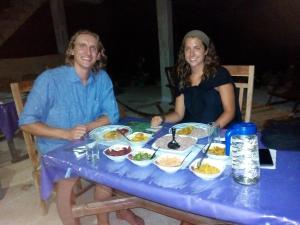 two women sitting at a table with plates of food at Nimsara Homestay in Ella