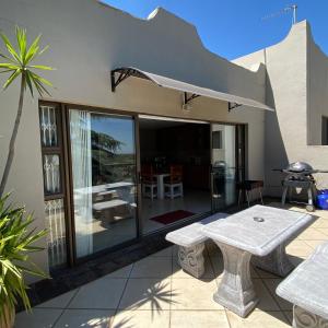 a patio with a table and a patio umbrella at Glenvista Home with a View in Johannesburg
