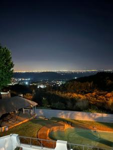 a view of a golf course at night at Glenvista Home with a View in Johannesburg