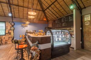 a fast food restaurant with a counter and chairs at Rimkao Valley Resort in Suan Phung