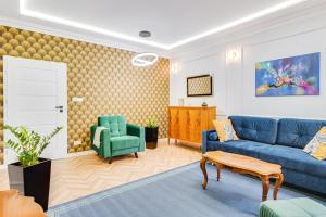 a living room with a blue couch and a green chair at Pleasant Apart ~ 700m Main Square - Self check-in 24h in Wrocław