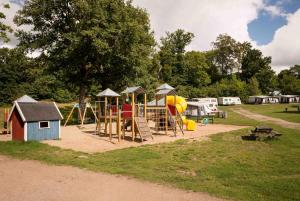 a park with a playground with a slide and play equipment at First Camp Skönstavik Karlskrona in Karlskrona