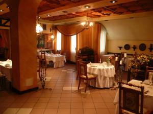 a dining room with two tables with white tablecloths at Azymut Hotel - Restauracja in Andrespol