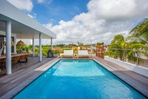 a swimming pool on the balcony of a house at Villa Flamingo - LXRYHOME Collection in Jan Thiel +26 photos