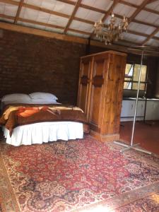 a bedroom with a bed and a chandelier at African feel studio with kitchenette - 2045 in Harare
