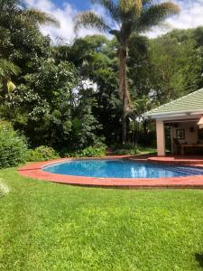 a swimming pool in the yard of a house at African feel studio with kitchenette - 2045 in Harare