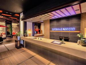 a lobby with a reception counter and a restaurant at LiVEMAX RESORT Aki Miyajima in Miyajima