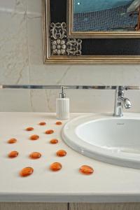 a bathroom sink with carrots on a counter at Elounda Maris Villas in Elounda