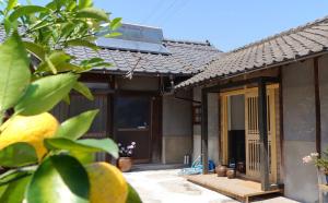 a house with an open door in front of it at 離島-宿navelの学校-三原港から船で14分 in Mihara