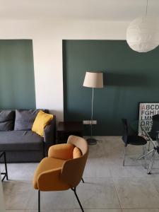 a living room with a couch and a chair at Lykavitos Apartments in Nicosia