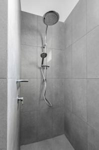 a shower with a shower head in a bathroom at Reflections Urunga - Holiday Park in Urunga