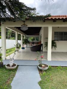 a porch of a house with two potted plants at POUSADA ACONCHEGO MT in Chapada dos Guimarães