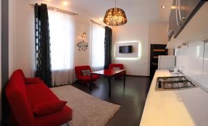a living room with a red couch and a table at Ekaterina Hotel in Odesa