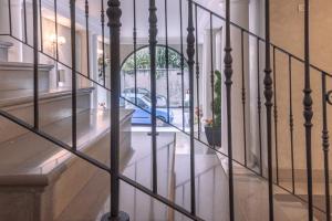 a view of a hallway through a wrought iron fence at Residence Rialto in Trieste