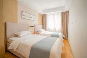 Ένα ή περισσότερα κρεβάτια σε δωμάτιο στο Home Plus Hotel