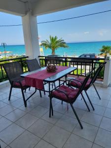stół i krzesła na balkonie z plażą w obiekcie Cozy maisonette in Pefkochori Chalkidiki w mieście Pefkochori