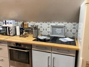a kitchen with a counter with a laptop computer on it at L Atypik à L ancienne forge in Muhlbach-sur-Munster