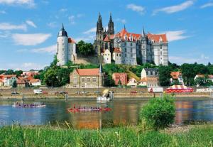 a group of people in kayaks on the river in front of a castle at Z Testhotel Zur Sonne in Dresden