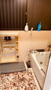 a bathroom with a bath tub and a shower at 湘南の丘のヴィラーSweet Room in Fujisawa