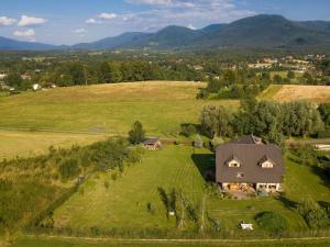 an aerial view of a house on a green field at Na Helštýně in Frenštát pod Radhoštěm