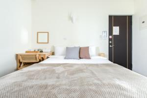 Postel nebo postele na pokoji v ubytování Taitung Bear Station Inn