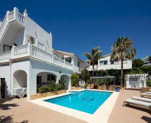 a villa with a swimming pool and a house at Family Villa Mijas-Costa close to the beach in Fuengirola