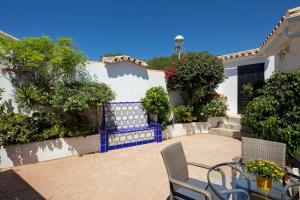 a patio with a table and chairs in front of a house at Family Villa Mijas-Costa close to the beach in Fuengirola