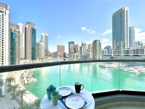 a balcony with a view of the water in a city at White Sage - Marina Gem, Fancy Apartment with Waterfront Views in Dubai