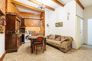 a living room with a couch and a table at Art House Petunia in Tbilisi City