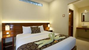 Postel nebo postele na pokoji v ubytování S5 Guest House Yogyakarta