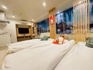 大阪的住宿－東瀛Stays 301北海道 クールな和室部屋，一间配有电视的客房内的一张大白色床