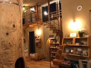 a living room with a spiral staircase in a house at Family Hotel Matsumoto Satoyama Doors in Matsumoto