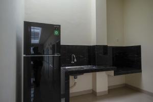 梭羅的住宿－RedDoorz Plus near UMS Solo 2，黑色浴室设有水槽和镜子